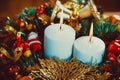 Christmas wreath with burning candles on wooden table Royalty Free Stock Photo