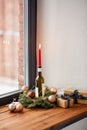 christmas wreath with candle burning on bottle Royalty Free Stock Photo