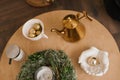 Christmas wreath, candle, golden teapot, Christmas tree toys on the table in the living room decor