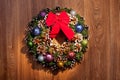 Christmas wreath with cones and Christmas toys and a red bow. Royalty Free Stock Photo