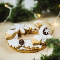 Christmas wreath with cookies. New Year's gift of gingerbread. Christmas tree decorated with lights Royalty Free Stock Photo