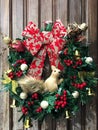 Christmas wreath decorated with bows, bells, berries and a squirrel