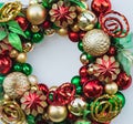 Christmas wreath decorated with gold and red balls, lights, isolated on white. Christmas wreath hanging on white door Royalty Free Stock Photo