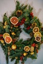 Christmas wreath decorated with pieces of dried fruits and cones Royalty Free Stock Photo
