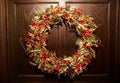 Christmas wreath decorated with red winterberries and pine cones Royalty Free Stock Photo