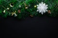 Christmas wreath decorated with a white snowflake and golden bells, balls, cones