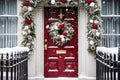 Christmas wreath and decoration on a classic red door on snowing winter holiday, Merry Christmas and Happy Holidays wishes, Royalty Free Stock Photo