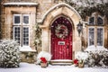 Christmas wreath and decoration on a classic red door on snowing winter holiday, Merry Christmas and Happy Holidays wishes, Royalty Free Stock Photo