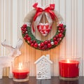 Christmas Wreath Decoration with red berries and red ribbon bow. Royalty Free Stock Photo