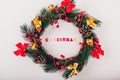 Christmas wreath with decoration on white background. Christmas title made of colorful wooden letters