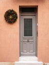 Christmas wreath decoration. Wooden entrance door in old town of Plaka, Athens Greece Royalty Free Stock Photo