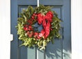 A Christmas wreath on the door to an office building