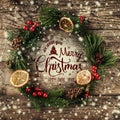 Christmas wreath of Fir branches, cones, red decorations on dark wooden background. Xmas and Happy New Year theme Royalty Free Stock Photo