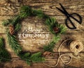 Christmas wreath of Fir branches, cones, scissors and skein of jute on dark wooden background. Xmas and Happy New Year theme, snow Royalty Free Stock Photo