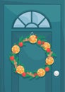 Christmas wreath of fir branches on the front door. Wreath of fir branches decorated with dried oranges, cinnamon sticks and