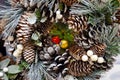 Christmas wreath from fir, pine and spruce twigs with cones, berries and snow as background - Image