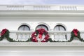 Christmas Wreath and Garland Hanging from a White Mansion