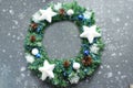 Christmas wreath gently on grey wooden background