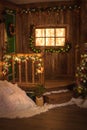 Christmas wreath on green door, a window decorated w wooden bac Royalty Free Stock Photo