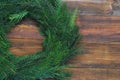 Christmas wreath of green fir Branches on a wooden background with Copy Space