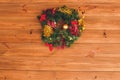 Christmas wreath handmade on a wooden background. Festive lights of garland. New Year`s interior decoration. Royalty Free Stock Photo