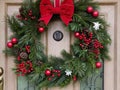 A Christmas wreath hanging on a front door,. Generated AI Royalty Free Stock Photo