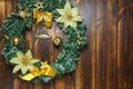 Christmas wreath hanging on wooden door front view. Decoration concept Royalty Free Stock Photo