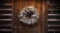 Christmas wreath hanging on a wooden door, with snow gently falling around it, creating a cozy and welcoming scene Royalty Free Stock Photo