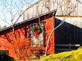 A Festive Wreath Adorns a Weathered Barn Door Royalty Free Stock Photo