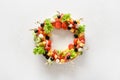 Christmas wreath of holiday snacks, canapes, tomatoes, olive, vegetables, cheese