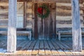 Christmas Wreath Hung on the Log Cabin Door Royalty Free Stock Photo