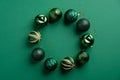 Christmas wreath made of balls decoration on green background. Flat lay style composition, top view Royalty Free Stock Photo