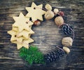 Christmas wreath made from cookies, nuts, pine cones and fir branches