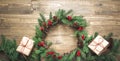 Christmas wreath made of spruce branches with gifts on wooden board. Flat lay. Top view. Royalty Free Stock Photo