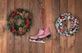 christmas wreath and ice skates on wooden wall Royalty Free Stock Photo