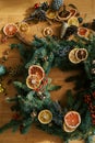 Christmas wreath of pieces of dried fruits and berries lies on the floor. Top view. Cropped