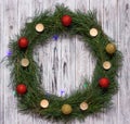 Christmas wreath of pine branches with candles on a white wooden background, Christmas balls, copy space Royalty Free Stock Photo