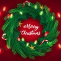 Christmas Wreath Pine Branches with Yellow Stars and Candy Canes and sparkling lights garland on red background Royalty Free Stock Photo