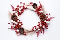 A Christmas wreath with red berries and pine cone, with a white background. Generative AI