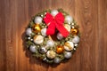 Christmas wreath with a red bow and Christmas toys balls. Royalty Free Stock Photo