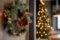Christmas wreath with red bow and pinecones, tree in background Royalty Free Stock Photo