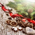 Christmas wreath with red ribbon and fir branches over old wood Royalty Free Stock Photo