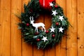 Christmas wreath with reindeer on a front wooden door Royalty Free Stock Photo
