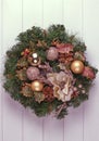 Christmas wreath on a rustic wooden front door. Royalty Free Stock Photo