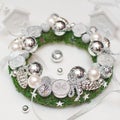 Christmas wreath with silver decorations and candles on white background Royalty Free Stock Photo