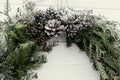 Christmas wreath. stylish rustic christmas wreath on white wooden door with pine cones,fir branches,snow. space for text. Royalty Free Stock Photo