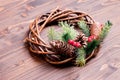 Christmas wreath of twigs with pine needles and cones on a brown Royalty Free Stock Photo