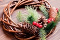 Christmas wreath of twigs with pine needles and cones on a brown Royalty Free Stock Photo