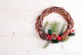 Christmas wreath of twigs with pine needles and cones on light b Royalty Free Stock Photo