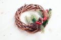 Christmas wreath of twigs with pine needles and cones on light b Royalty Free Stock Photo